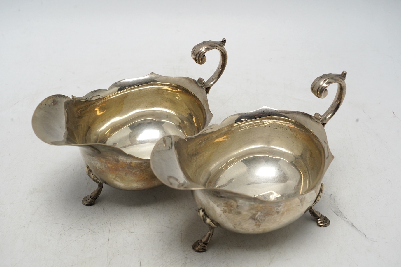 A pair of George V silver sauce boats, Nathan & Hayes, Chester, 1915, length 16.1cm, 12.6oz. Condition - fair